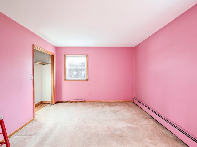 unfurnished bedroom featuring baseboard heating, light carpet, and a closet