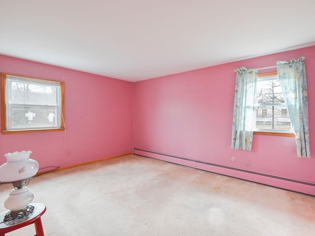 unfurnished room featuring light carpet and a baseboard radiator