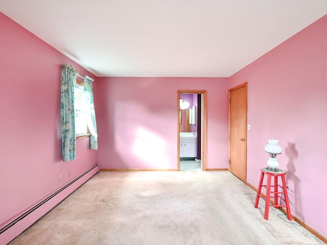 carpeted empty room with a baseboard radiator