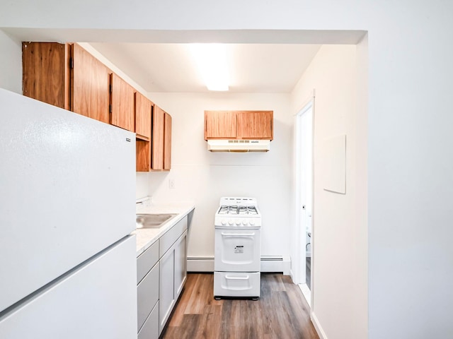 kitchen featuring sink, dark hardwood / wood-style flooring, white appliances, and a baseboard heating unit