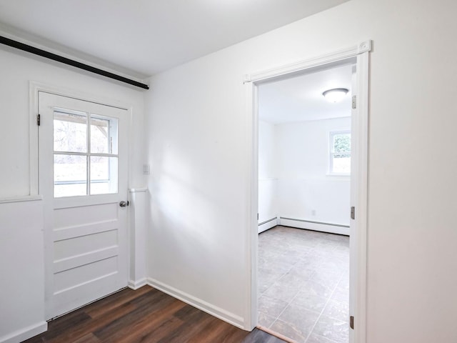 entryway featuring baseboard heating and dark wood-type flooring