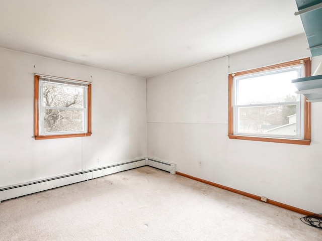 spare room featuring plenty of natural light, carpet, and a baseboard radiator