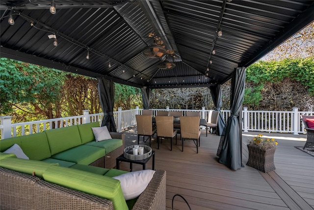 wooden deck featuring an outdoor living space, a gazebo, and ceiling fan