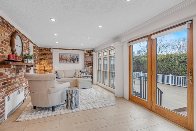 tiled living room with ornamental molding, brick wall, and radiator heating unit