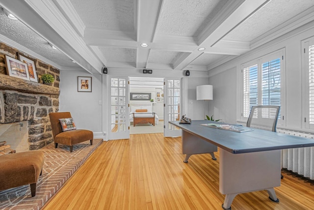 office space with french doors, coffered ceiling, crown molding, light hardwood / wood-style flooring, and beam ceiling