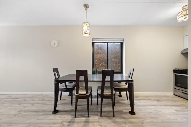 dining space with light hardwood / wood-style floors