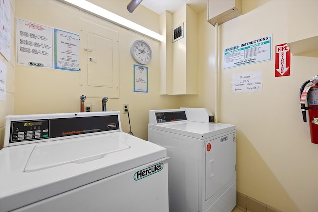 clothes washing area with separate washer and dryer