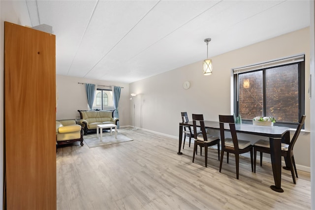 dining space with light hardwood / wood-style floors