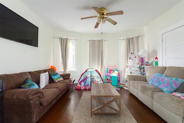 living room with ceiling fan and dark hardwood / wood-style flooring