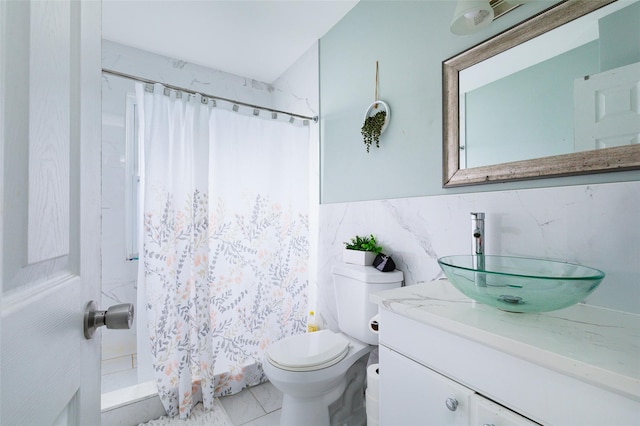 bathroom with a shower with curtain, vanity, toilet, and tile walls