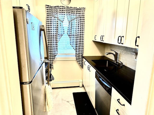 kitchen featuring decorative backsplash, appliances with stainless steel finishes, baseboard heating, sink, and white cabinetry