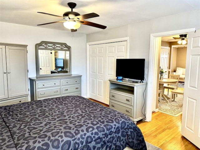 bedroom with ceiling fan, light hardwood / wood-style flooring, and a closet