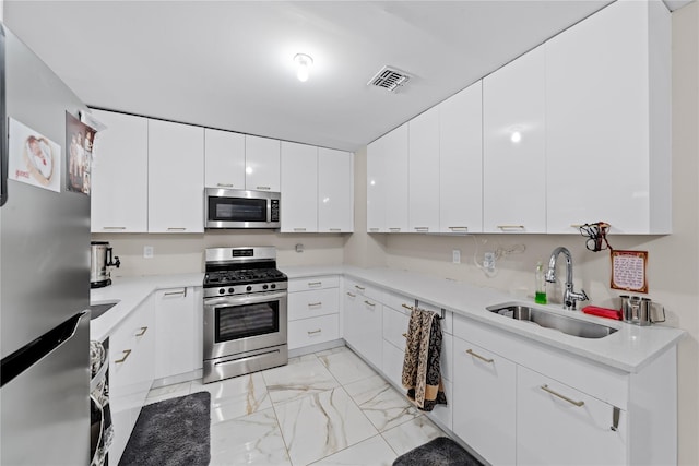 kitchen featuring white cabinetry, sink, and stainless steel appliances