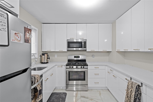 kitchen featuring white cabinets, sink, and stainless steel appliances