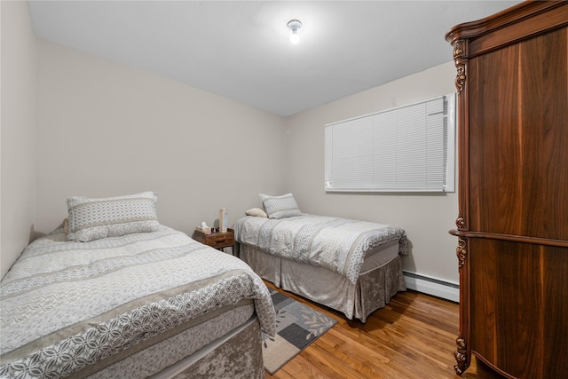 bedroom featuring a baseboard radiator and wood-type flooring