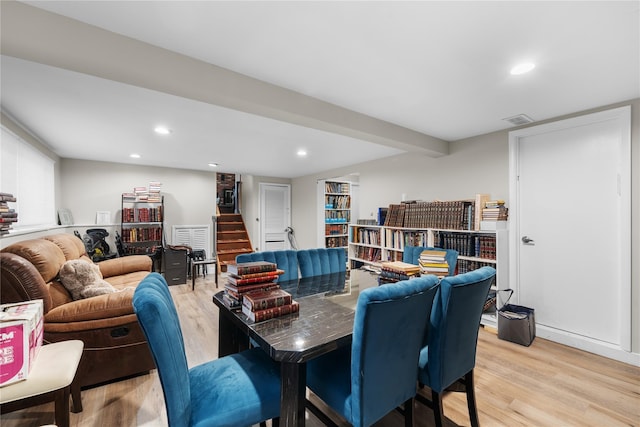 interior space with beamed ceiling and light hardwood / wood-style flooring