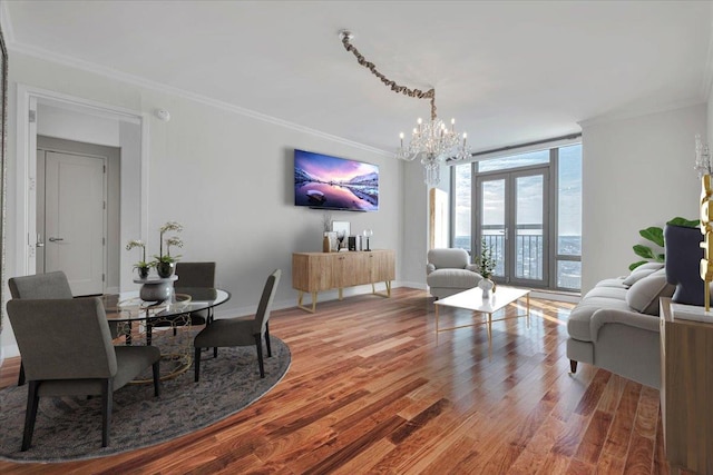 dining room with expansive windows, ornamental molding, an inviting chandelier, and hardwood / wood-style floors