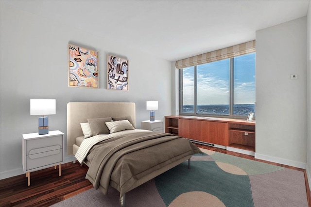 bedroom with dark wood-type flooring and a water view