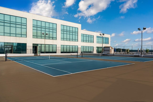 view of tennis court with basketball hoop