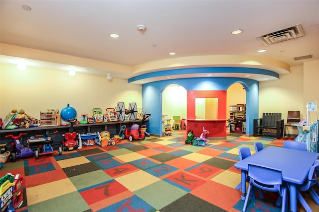 playroom with recessed lighting, visible vents, and arched walkways