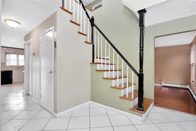 staircase with tile patterned flooring and sink