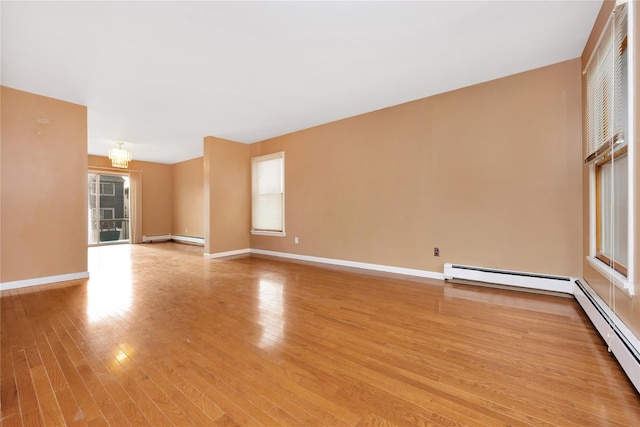 interior space featuring light hardwood / wood-style flooring, a chandelier, and a baseboard radiator