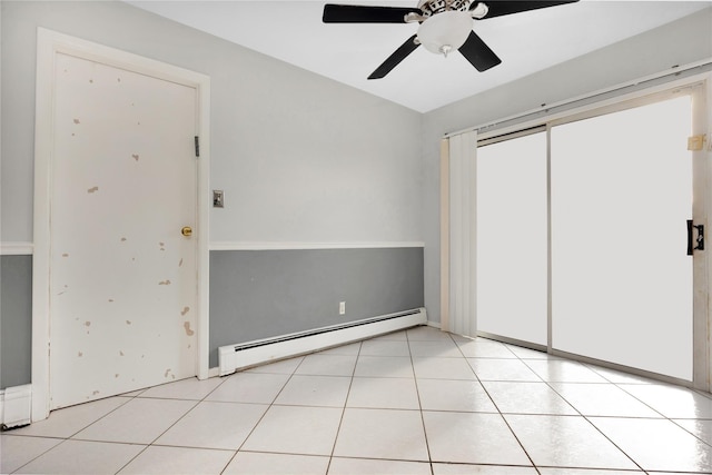 unfurnished bedroom with ceiling fan, light tile patterned floors, and baseboard heating