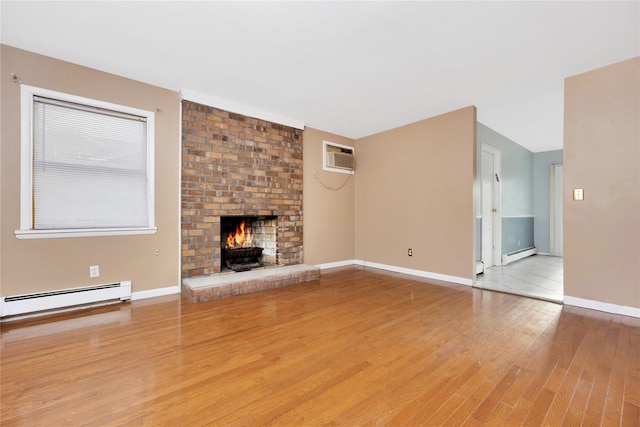 unfurnished living room featuring light wood-type flooring, baseboard heating, and a brick fireplace