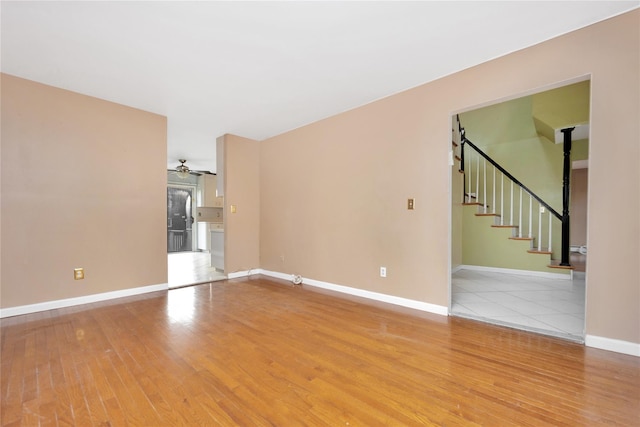 spare room with hardwood / wood-style floors and ceiling fan