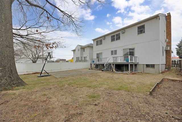 back of property featuring a yard and a deck