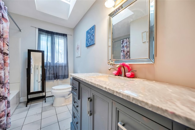 full bathroom featuring a skylight, vanity, shower / bathtub combination with curtain, tile patterned flooring, and toilet