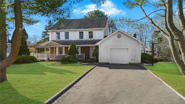 view of front facade with a garage, covered porch, and a front lawn