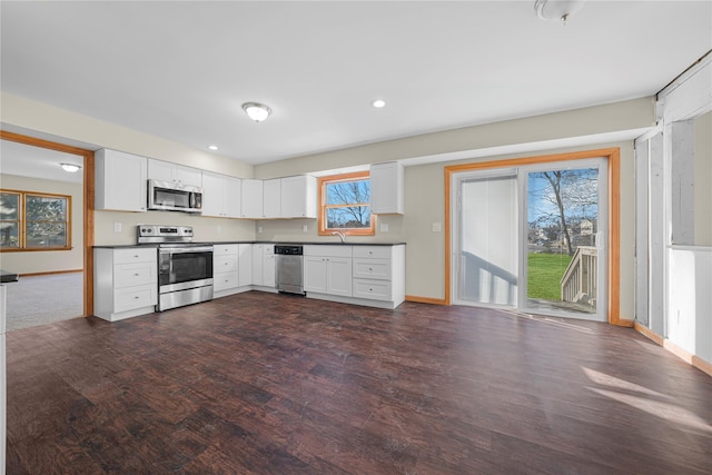 kitchen featuring white cabinets, dark hardwood / wood-style floors, and appliances with stainless steel finishes