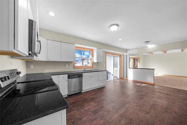 kitchen featuring white cabinetry, sink, stainless steel appliances, and dark hardwood / wood-style floors