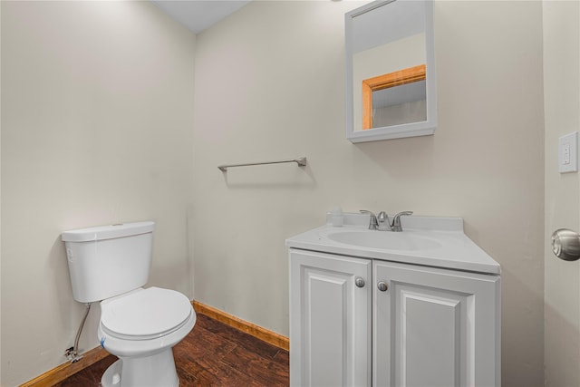 bathroom with hardwood / wood-style floors, vanity, and toilet