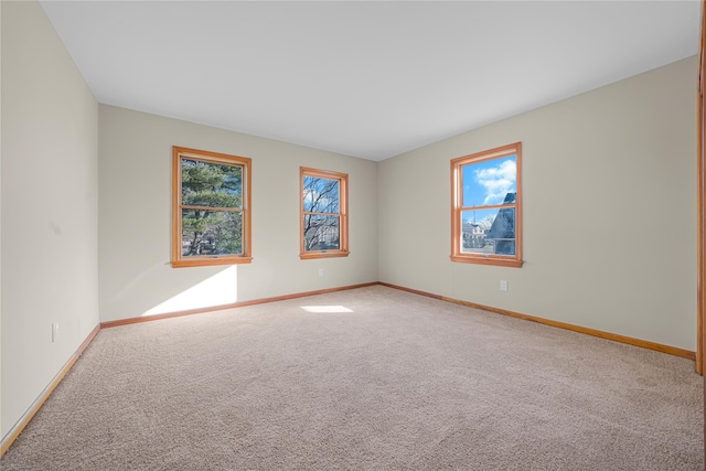 carpeted empty room featuring a wealth of natural light