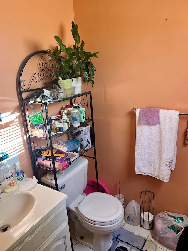 bathroom with tile patterned floors, vanity, and toilet