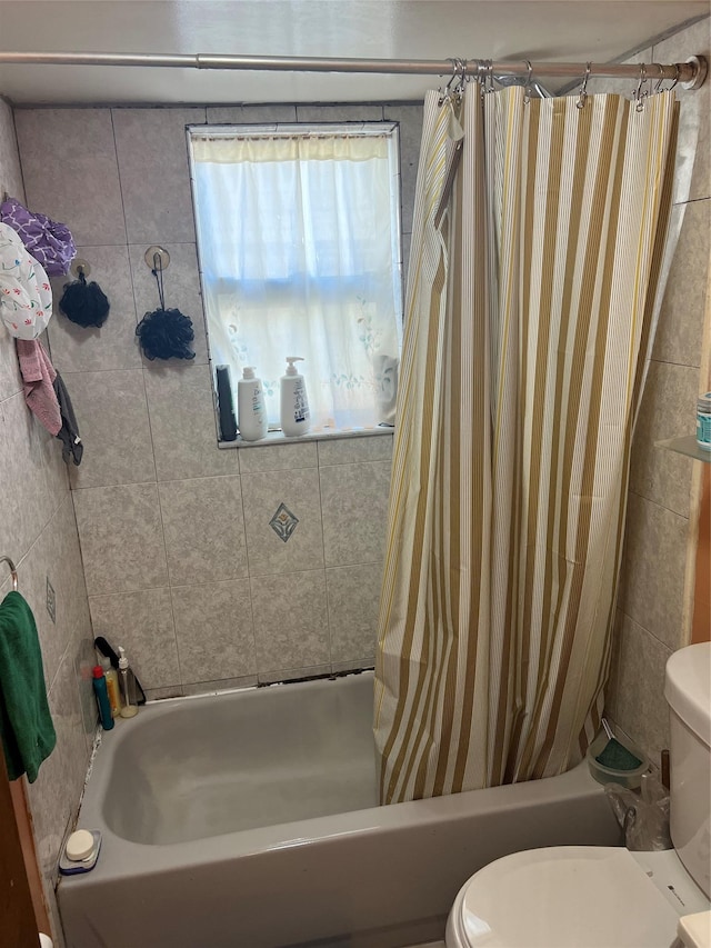 bathroom featuring toilet and shower / tub combo with curtain