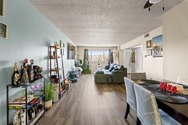 interior space with hardwood / wood-style flooring, ceiling fan, and a textured ceiling