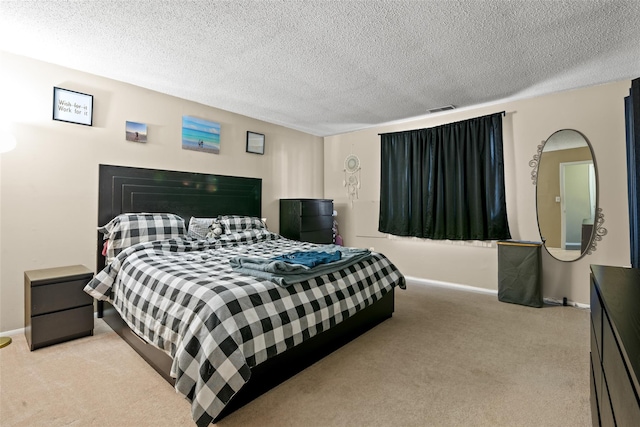 carpeted bedroom featuring a textured ceiling