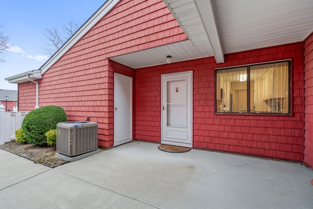 doorway to property featuring a patio area and cooling unit