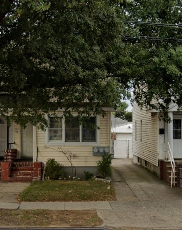 view of front of house with a garage and an outdoor structure