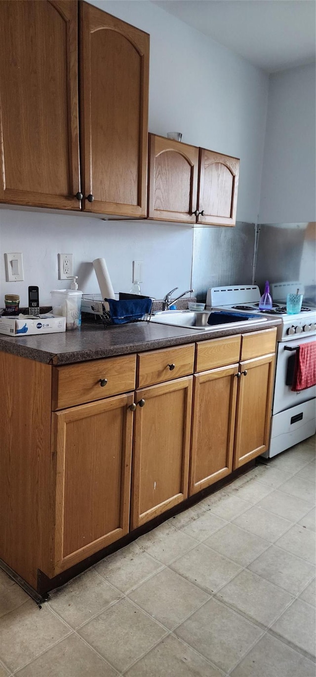 kitchen with white gas range oven and sink