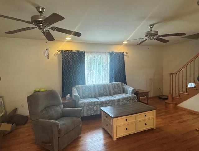 living room featuring ceiling fan and dark hardwood / wood-style flooring