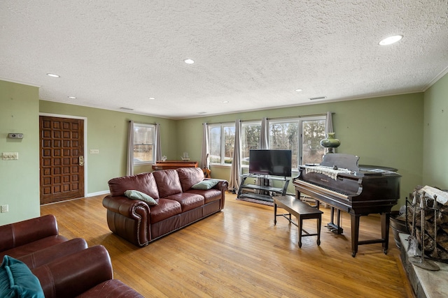 living room featuring light hardwood / wood-style flooring and a textured ceiling