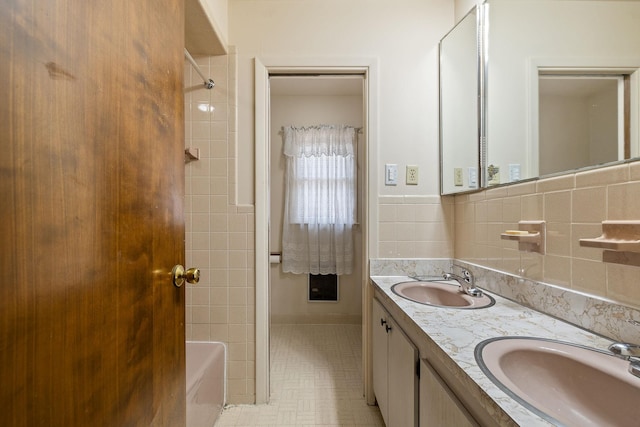 bathroom featuring shower / bathing tub combination, vanity, and tile walls