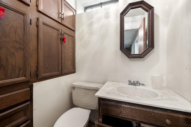 bathroom with toilet and vanity