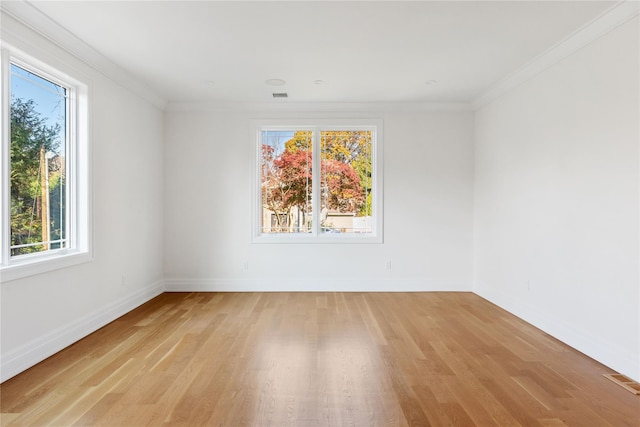 unfurnished room featuring light wood-type flooring and ornamental molding