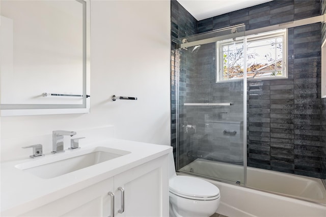 full bathroom with enclosed tub / shower combo, toilet, and vanity