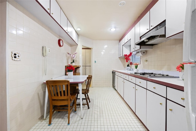 kitchen featuring white gas cooktop, sink, tile walls, dishwasher, and white cabinetry